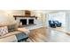Cozy living room featuring a brick fireplace, wood floors, and comfortable seating at 4004 Claremont Dr, New Port Richey, FL 34652