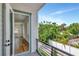 Balcony view showcasing the exterior with lush greenery and interior with hardwood floors and natural light at 407 S Albany Ave # 4, Tampa, FL 33606