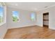 Bright bedroom with hardwood floors, white walls, and dual windows, and a large walk-in closet at 407 S Albany Ave # 4, Tampa, FL 33606