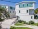 Charming three-story home with a modern white and green facade, steps to the front door and a garage entrance at 407 S Albany Ave # 4, Tampa, FL 33606
