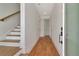 Bright hallway with hardwood floors, a staircase, and doors leading to other rooms in the home at 407 S Albany Ave # 4, Tampa, FL 33606