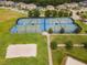 Aerial view of tennis, basketball, and volleyball courts at 9157 Bella Vita Cir, Land O Lakes, FL 34637