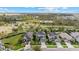 Aerial view of a two-story house, neighborhood, and pond at 9157 Bella Vita Cir, Land O Lakes, FL 34637