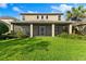 Two-story home with a large screened patio and lush lawn at 9157 Bella Vita Cir, Land O Lakes, FL 34637