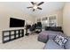 Comfortable bedroom with a bed, TV, desk, and plenty of natural light at 9157 Bella Vita Cir, Land O Lakes, FL 34637