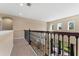Open loft area overlooking the living room with a railing and carpet flooring at 9157 Bella Vita Cir, Land O Lakes, FL 34637
