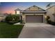Two-story house with a two-car garage at dusk at 9157 Bella Vita Cir, Land O Lakes, FL 34637