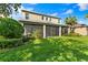 Two story home exterior, screened patio, and spacious backyard at 9157 Bella Vita Cir, Land O Lakes, FL 34637