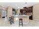 Kitchen island with granite countertops and bar stools at 9157 Bella Vita Cir, Land O Lakes, FL 34637