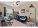 Bedroom with a comfortable couch, musical instruments, and home office at 9157 Bella Vita Cir, Land O Lakes, FL 34637