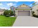 Two-story house with a two-car garage and landscaped lawn at 9157 Bella Vita Cir, Land O Lakes, FL 34637