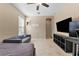 Versatile bedroom with a sofa bed, TV, and access to a hallway at 9157 Bella Vita Cir, Land O Lakes, FL 34637
