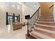 Spacious living area with high ceilings, a view of the backyard, and access to the stairs at 9157 Bella Vita Cir, Land O Lakes, FL 34637