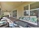 Spacious screened patio with wicker furniture and a view of the backyard at 9157 Bella Vita Cir, Land O Lakes, FL 34637