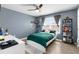 Cozy bedroom featuring a green bedspread and a wall-mounted shelf at 3128 S Northview Rd, Plant City, FL 33566