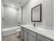 Modern bathroom with white tiled walls, shower, bathtub, and sleek vanity at 12152 Snow Bird Ave, Port Charlotte, FL 33981