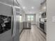 Modern kitchen equipped with stainless steel appliances, gray cabinets, and durable floors at 12152 Snow Bird Ave, Port Charlotte, FL 33981