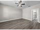 Spacious primary bedroom with sleek ceiling fan and luxury vinyl plank flooring at 12152 Snow Bird Ave, Port Charlotte, FL 33981