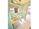 Bathroom with a vanity, toilet, and pastel-green tile at 14018 Thacher Ave, Largo, FL 33774