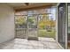 Screened porch with a view of the fenced backyard and fire pit at 14459 Mirabelle Vista Cir, Tampa, FL 33626