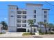 Modern building exterior with parking and landscaping at 211 Dolphin Pt # 202, Clearwater Beach, FL 33767