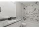 Clean bathroom with a bathtub and marble tile at 211 Dolphin Pt # 202, Clearwater Beach, FL 33767
