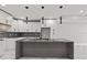 Modern kitchen with marble countertops and island at 211 Dolphin Pt # 202, Clearwater Beach, FL 33767