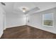 Spacious main bedroom with tray ceiling, large windows, and dark wood-look floors at 2122 Richwood Pike Dr, Ruskin, FL 33570