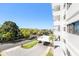 Exterior shot of the condo with well-maintained landscaping, street view and elegant white facade on a sunny day at 30 Turner St # 401, Clearwater, FL 33756