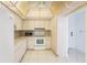 Bright kitchen featuring white cabinetry, appliances, and tile flooring at 30 Turner St # 401, Clearwater, FL 33756