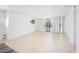 Bright living room featuring tile flooring, fan, and sliding doors to the balcony at 30 Turner St # 401, Clearwater, FL 33756