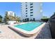 Inviting community pool with poolside seating, mature landscaping, and clear water for relaxation and enjoyment at 30 Turner St # 401, Clearwater, FL 33756