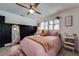 Bedroom with a ceiling fan, a full-length mirror and wood-look floors at 3208 San Carlos St, Clearwater, FL 33759