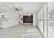 Bright living room featuring tile floors, plantation shutters, and a modern accent wall at 3208 San Carlos St, Clearwater, FL 33759