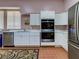 Modern community kitchen with double oven and refrigerator at 8676 Fantasia Park Way, Riverview, FL 33578