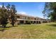 Rear view of townhomes with grassy area at 2210 Lake Woodberry Cir, Brandon, FL 33510