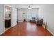 Living room with hardwood floors, gray sectional sofa, and access to a half bath at 2210 Lake Woodberry Cir, Brandon, FL 33510