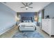 Spacious main bedroom with a king-size bed, dresser, and ceiling fan at 11339 Tayport Loop, New Port Richey, FL 34654