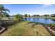 Peaceful backyard with a picturesque lake view and grassy area at 11339 Tayport Loop, New Port Richey, FL 34654