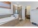 Bathroom with soaking tub, walk-in shower, and large closet at 11339 Tayport Loop, New Port Richey, FL 34654