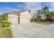 Two-story house with a three-car garage at 11339 Tayport Loop, New Port Richey, FL 34654