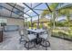Screened patio with fire pit and seating area at 11339 Tayport Loop, New Port Richey, FL 34654
