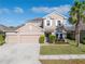 Two-story house with a three-car garage at 11339 Tayport Loop, New Port Richey, FL 34654