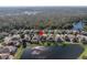 Aerial view of a house near a lake at 11339 Tayport Loop, New Port Richey, FL 34654