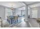 Open dining room and living area, featuring light-grey walls and a modern chandelier at 11339 Tayport Loop, New Port Richey, FL 34654