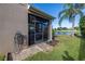Landscaped backyard with screened enclosure at 11339 Tayport Loop, New Port Richey, FL 34654