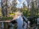 Private boat dock on a serene lake with a wooden walkway at 11339 Tayport Loop, New Port Richey, FL 34654