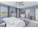 Main bedroom with king bed, lake view, and walk-in closet at 11339 Tayport Loop, New Port Richey, FL 34654