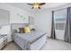 Cozy bedroom with a light wood platform bed and gray walls at 11339 Tayport Loop, New Port Richey, FL 34654
