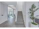 Elegant staircase with gray carpeting and white railings at 11339 Tayport Loop, New Port Richey, FL 34654